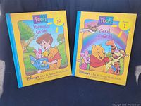 Photo of two vintage Winnie The Pooh children's books, Volume 1 and Volume 19, front covers facing up
