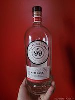 Photo clearly showing the empty Wayne Gretzky No. 99 Red Cask Canadian Whiskey bottle held in hand for scale. Labels and bottle details visible.