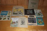 Full view of all 10 bird books arranged on a wooden surface