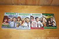 Four Married with Children DVD box sets arranged side by side, showing seasons one, two, three, and nine with their cover artwork.