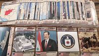 Photo showing trading cards spread out in rows, including cards depicting geographic locations and notable figures related to Desert Storm.
