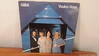 Front view of ABBA Voulez-Vous vinyl album cover showing band members and triangular light design.