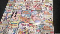 Photo of 15 Archie Comics digest comic books laid out on black surface, showing all front covers distinctly.