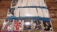 Complete set of hockey cards laid out in stacks showing front of cards with notable players visible.