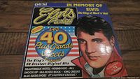 Front cover of the Elvis Presley vinyl record album with colorful graphics and text in French.
