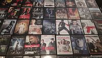 Overview image showing a grid of DVDs with clearly visible titles across multiple genres and actors.