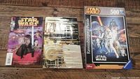 Photo of Star Wars comic, puzzle, and book showing their fronts and backs.