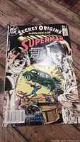 Front cover of the Superman #1 Secret Origins comic book showing the title, artwork of Superman lifting a car, and some signs of wear on edges and corners.