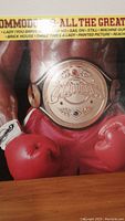 Close-up of album cover featuring a boxer wearing red boxing gloves and a championship belt with 'The Commodores' logo and track listing across the top.