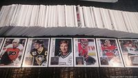 Photo showing a large collection of Upperdeck 1992-93 hockey cards laid out with several cards facing up featuring players in various team jerseys.
