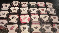 Top view showing 23 different NHL team jersey shaped coasters arranged in a grid, all displaying clear team logos and colors.