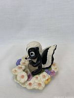 Front view of Flower skunk on flower base, showing facial details and multicolored flowers.