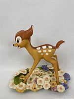Front diagonal view of Bambi 'Purty Flower' figurine on a detailed flower base.