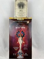 Original box for Dark Ivory statue by CS Moore Studio, showing design and branding.