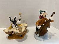 Overview of both Donald Duck and Goofy figurines on white background