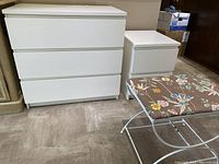 Photo showing dresser, bedside table, and metal bench together from the front