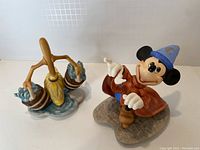Front angle of Mickey Mouse Mischievous Apprentice figurine and Bucket Brigade figurine showing colorful details and character poses.