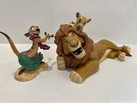 Both figurines displayed side by side showing size and color.