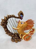 Front view of Classical Carp figurine showing harp-shaped base, orange detailed fish character playing strings.