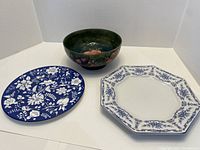 Overview of all three items: Moorcroft bowl at back, two plates at front