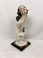 Front side view of the bust sculpture showing the detailed face and base.