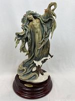 Front view of Sprite figurine on wooden base with brass nameplate