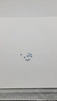 Ten small natural blue opal stones arranged on a white background, showing their blue color and oval shape.