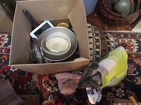 Box of miscellaneous vintage kitchenware including mixing bowl, pan, and framed mirror