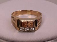 Front angle view showing rectangular bezel with three diamonds