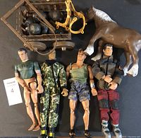 Four articulated male toy figures, a brown plastic horse, and a wooden buggy loaded with boulders and yellow reins.