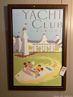 Full view of the framed Disney Yacht Club Resort canvas poster featuring Mickey and Minnie in a boat with the resort building in the background.