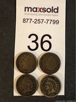 Front sides of four Indian Head coins showing the profile of a Native American with feather headdress.