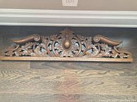 Full front view of the carved wall panel showing overall size and shape.