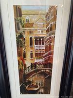 Full view of vertical framed print showing Venetian canal with boats and balconies on buildings