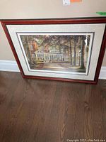 Full view of framed print leaning against wall