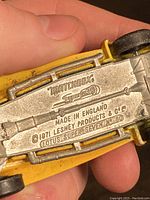 Underside of a yellow 1971 Matchbox Superfast Lotus Super Seven No. 60 car showing 'Made in England' and Lesney Products stamping.