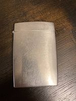 Closed view of the stainless steel hinged smokes holder case showing smooth polished surface