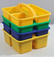 Stacked view of four plastic caddies with handles in yellow, green, blue, and yellow colors, showing the outline and shape clearly.