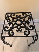 Top view photo showing square top with intricate scrollwork metal design.