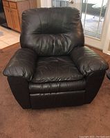 Front view of the dark brown vinyl recliner chair showing cushioned seat, back and armrests.