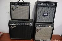 Four amps grouped: two Fender on left, Peavey top right, Fender small bottom right