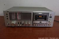 Front view of entire JVC KD-85 cassette deck on wooden surface