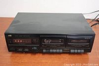 Full frontal image showing the JVC double cassette deck with two cassette compartments and control buttons.