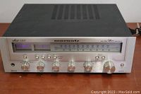 Front view showing controls, tuning dial, VU meters and power indicator
