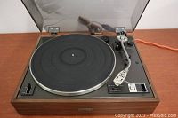 Full view of the Pioneer PL-15R turntable showing wood case, tonearm, platter, and clear dust cover open.