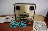 Front view of Pioneer RT-120L tape machine with reels and cases