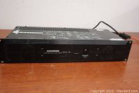 Full front view of the Samson Servo 260 amplifier showing front panel controls and branding.