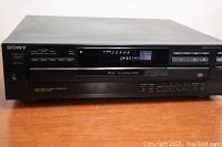 Front view of Sony CDP-C345 compact disc player showing power button, disc tray, multiple control buttons and LED display.