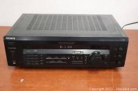Front view of Sony STR-DE335 receiver showing general condition and display screen with 5.1 CH indication.