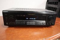 Front view of Sony STR-DE515 receiver showing power on and FM frequency 87.50 MHz on display.